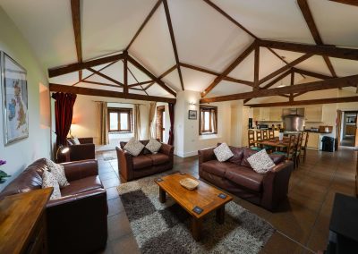 The whole openplan area of the Wheel House showing the comfy seating, dining and kitchen