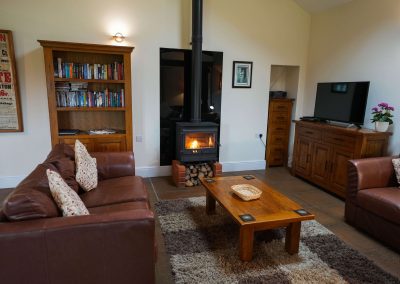 Comfy seating with the log burn lit in the Wheel House
