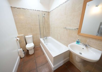 The Wheel House family bathroom with a shower over the bath
