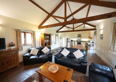 The openplan of the Leat House showing the comfy seating, dining table and kitchen.