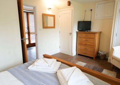 Bedroom in the Apple Loft with door open into hallway